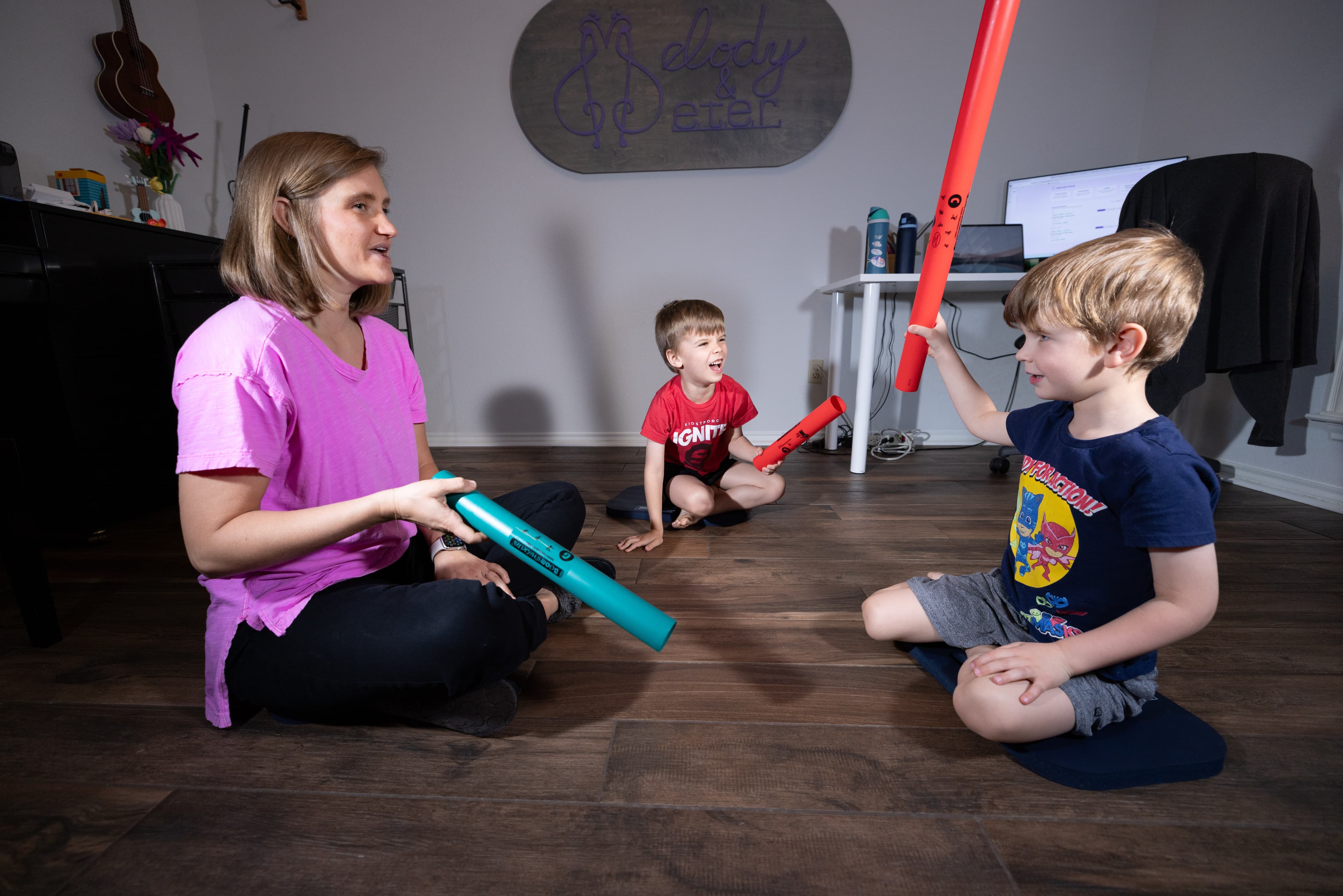 Children playing boomwhackers together in a group class